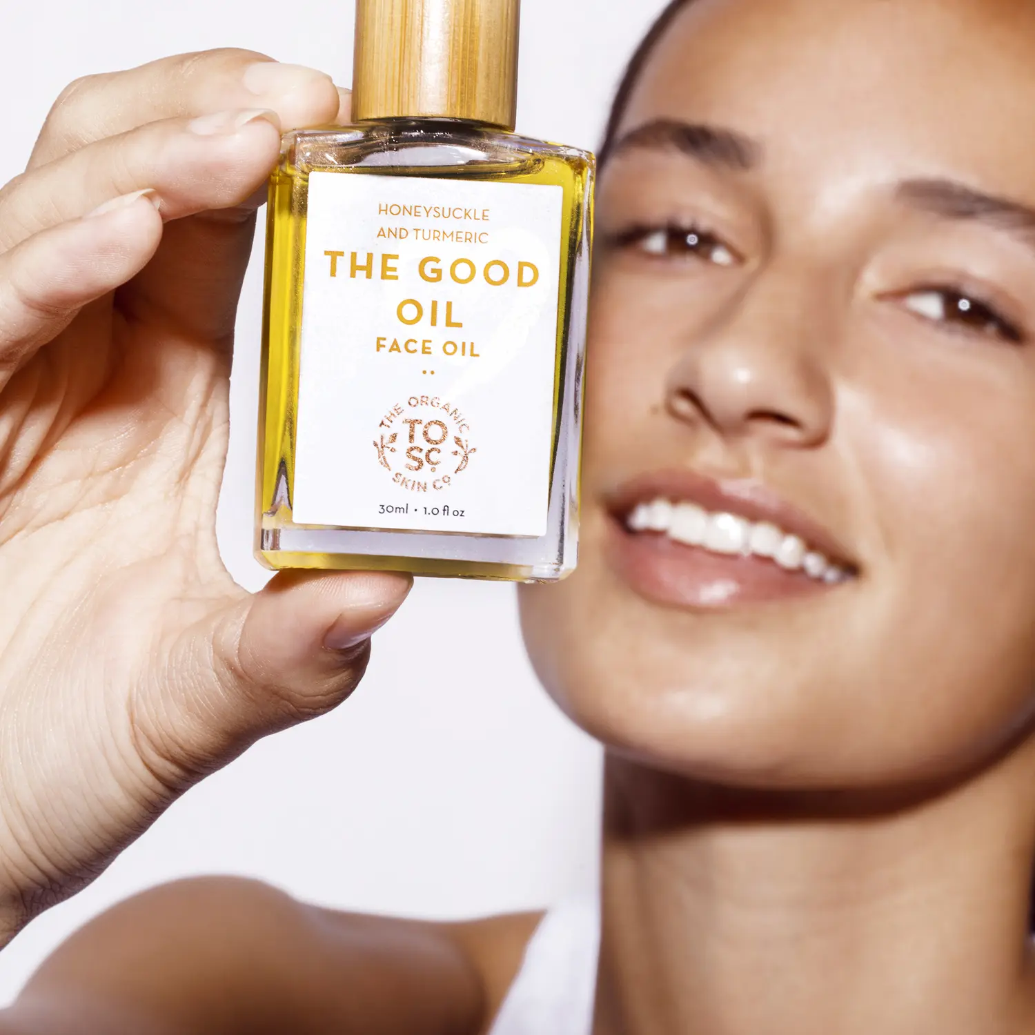 The Organic Skin Co. model holding The Good Oil face oil
